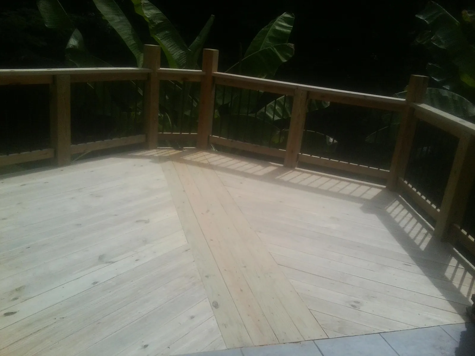 New wood deck and railing built off the back of a home in Oakville